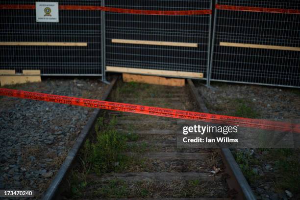 Police tape marks the outside boundary of the "red zone" crash site, on July 14, 2013 in Lac-Megantic, Quebec, Canada. A train derailed and exploded...