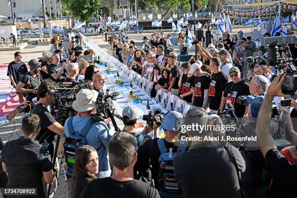 Families of the hostages participate in a special ‘Kabalat Shabbat,’ prayer service next to a "Shabbat Dinner" table set up in the Tel Aviv museum...