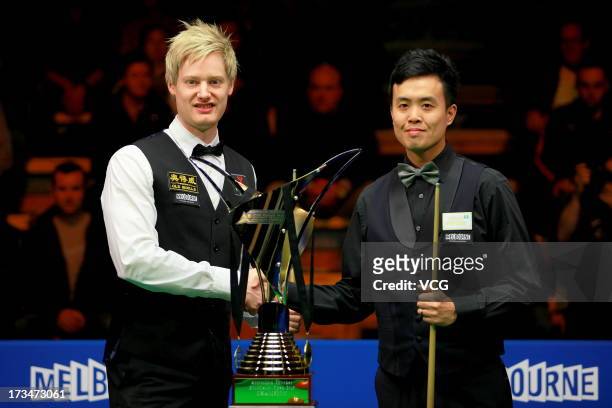 Neil Robertson of Australia and Marco Fu of Hong Kong shake hands after the final match of the World Snooker Australia Open at the Bendigo Stadium on...