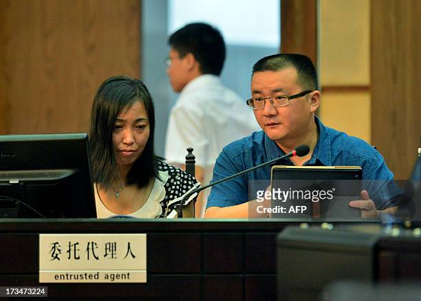 China rape victim's mother Tang Hui sits next to her lawyer in the Hunan Provincial People's High Court in Changsha, central China's Hunan province...