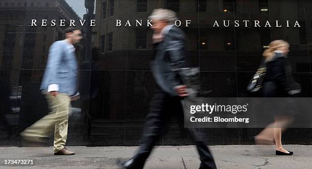 Pedestrians walk past the Reserve Bank of Australia headquarters in the central business district of Sydney, Australia, on Monday, July 15, 2013....