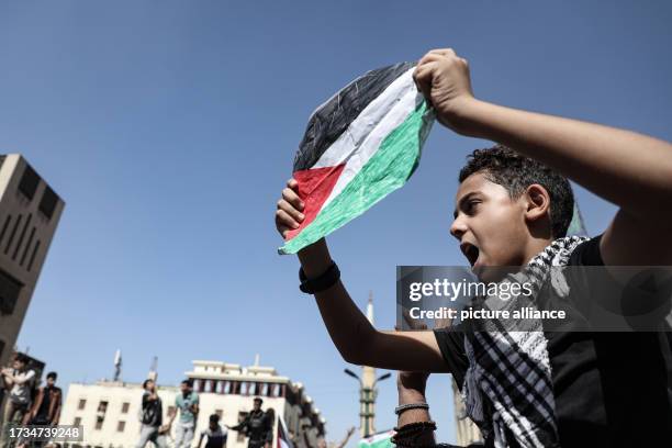 October 2023, Egypt, Cairo: An Egyptian boy holds a flag as he takes part in a protest in support of Palestinians at al-Azhar Mosque in Old Cairo....