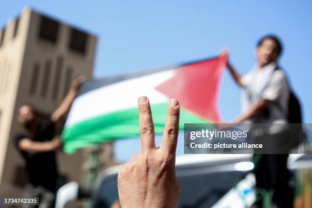 October 2023, Egypt, Cairo: A person flashes the victory sign as Egyptians take part in a protest in support of Palestinians at al-Azhar Mosque in...