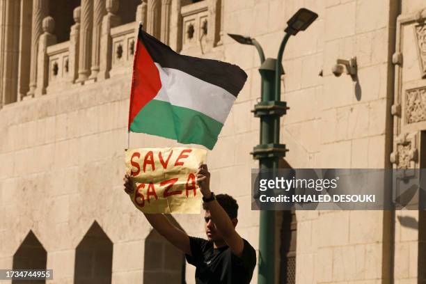 Man holds a sign that reads, 'Save Gaza', during a protest supporting the Palestinian people following Friday Noon prayers outside the al-Azhar...