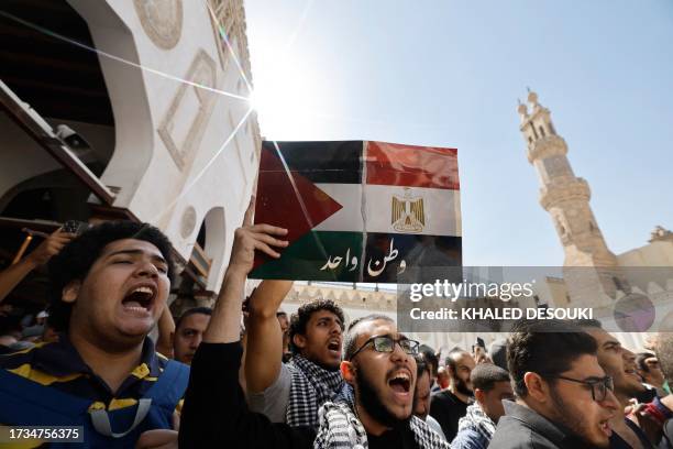 Man holds a sign showing the joined Palestinian and Egyptian flags with the words that read 'One nation', during a protest supporting the Palestinian...