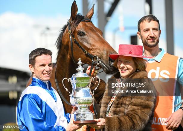 Tim Clark poses with the trophy with trainer Gai Waterhouse after riding Alligator Blood to win Race 7, the Neds Might And Power, during Melbourne...