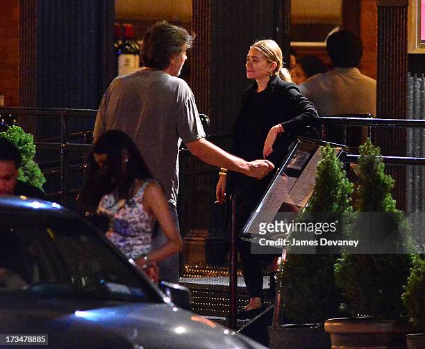 Mary-Kate Olsen and guest dine at Wolfgang's Steakhouse on July 14, 2013 in New York City.