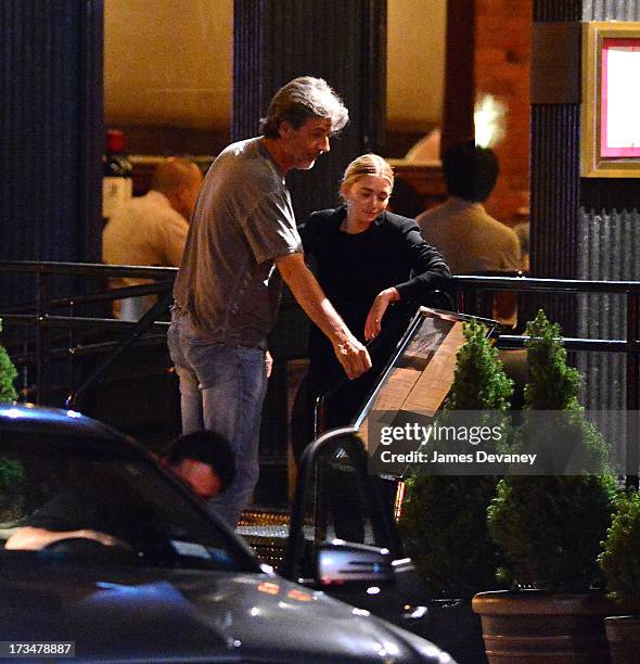 Mary-Kate Olsen and guest dine at Wolfgang's Steakhouse on July 14, 2013 in New York City.