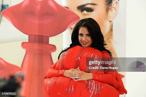 Katie Price poses as she launches her new fragrance 'Kissable' at The Work Studios on July 4, 2013 in London, England.