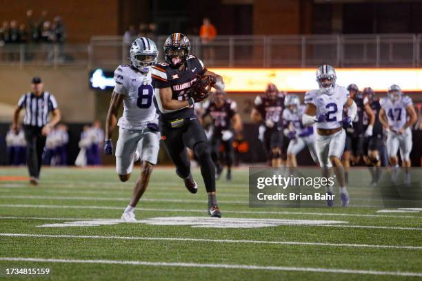 Wide receiver Rashod Owens of the Oklahoma State Cowboys takes a catch for a 45-yard gain against cornerback Will Lee III of the Kansas State...