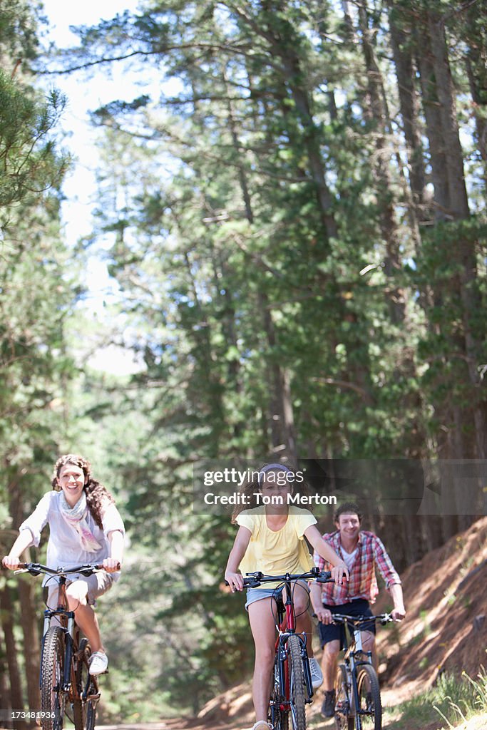 Family riding bicycles in woods