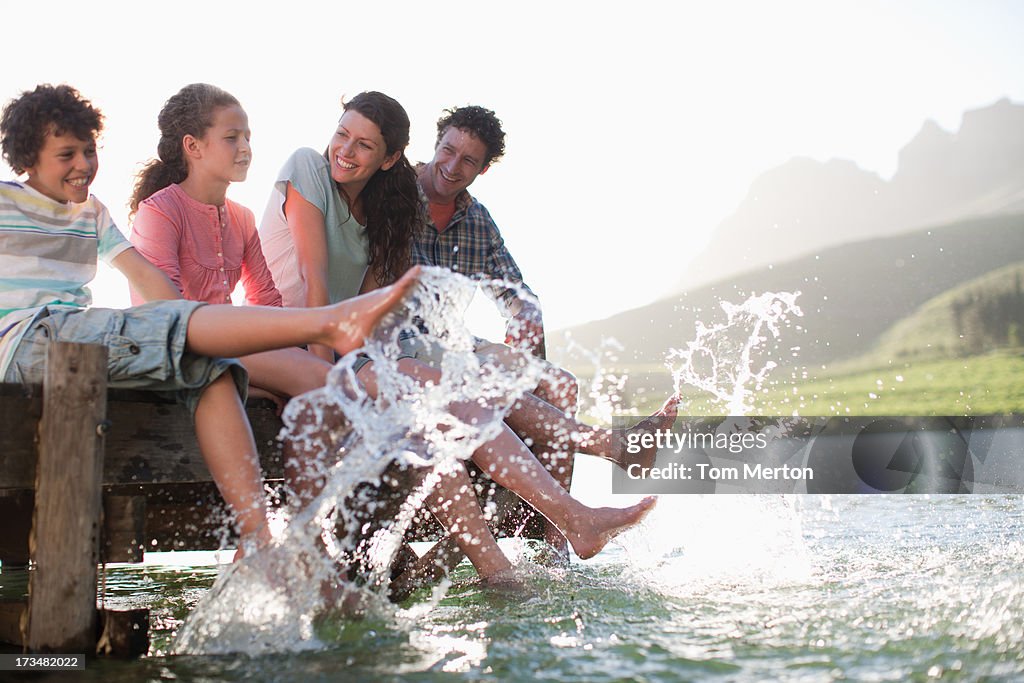 Family on dock splashing feet in lake