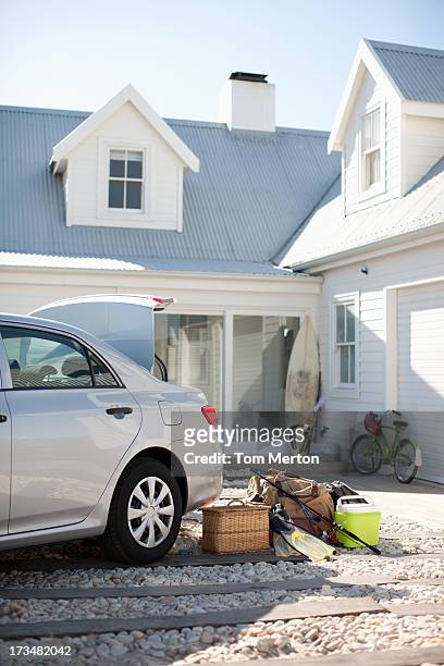 picnic basket, fishing rod, flippers and bags outside car in driveway - car on driveway bildbanksfoton och bilder