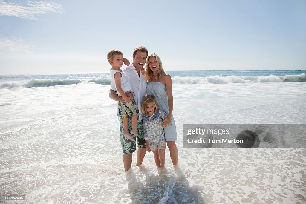 Family wading in ocean