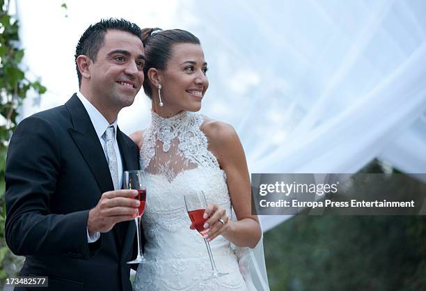 Barcelona football player Xavi Hernandez and Nuria Cunillera pose during their wedding at Marimurtra Botanical Gardens on July 13, 2013 in Blanes,...