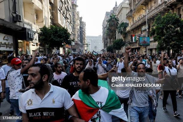 People march from Tahrir Square to the downtown district in the centre of Cairo on October 20, 2023 during a protest supporting the Palestinian...