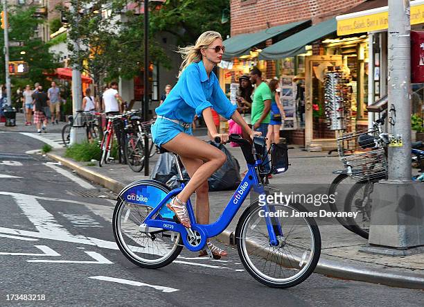 Karolina Kurkova rides a CitiBike on the streets of Manhattan on July 14, 2013 in New York City.