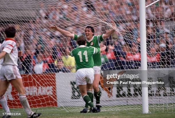 Tony Cascarino of the Republic of Ireland celebrates after scoring with teammate Kevin Sheedy during the FIFA World Cup qualification match between...