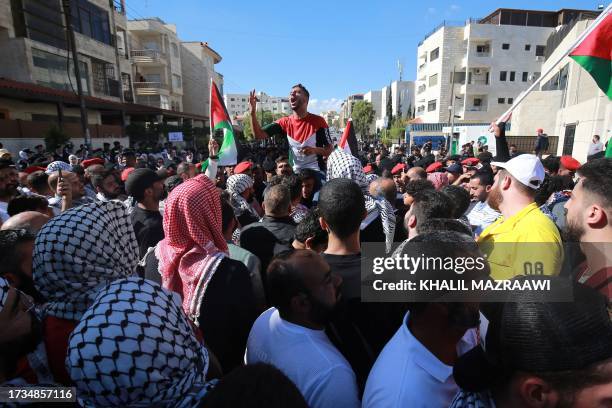 Demonstrators chant slogans near the Israeli Embassy in Amman on October 20 to show solidarity with the Palestinians of the Gaza Strip.