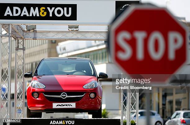 New Opel Adam automobile, produced by General Motor Co. , stands displayed for sale outside an Adam Opel AG car dealership in Rome, Italy, on...