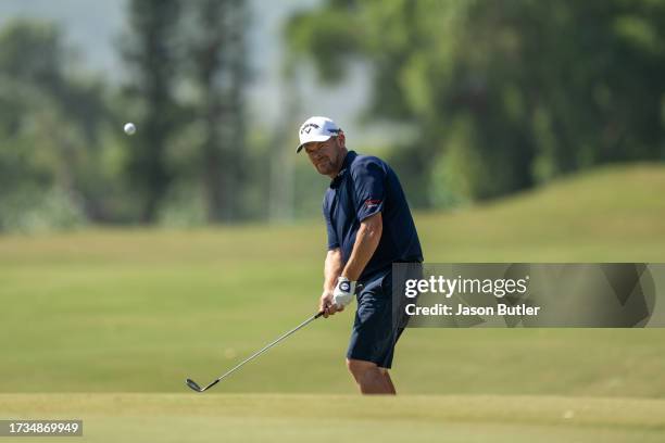 David Drysdale of Scotland chips onto the first green during the third round of the SJM Macao Open at Macau Golf and Country Club on October 14, 2023...