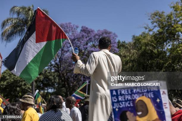 Pro Palestinian activists demonstrate outside the Israeli Embassy against the war in Gaza in Pretoria, on October 20, 2023.