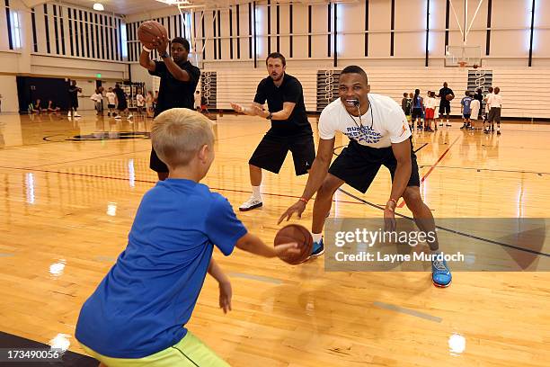 Oklahoma City Thunder Russell Westbrook coaches children at his basketball camp on July 10, 2013 at Heritage Hall in Oklahoma City, Oklahoma. NOTE TO...