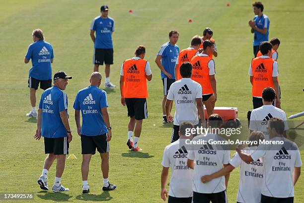 Head coach Carlo Ancelotti of Real Madrid speaks with assistant coach Zinedine Zidane as he takes his first training session with at the Valdebebas...