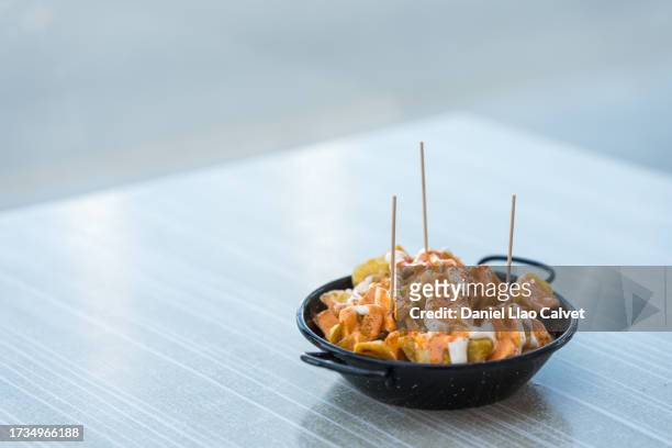 patatas bravas casserole - patatas chips stock pictures, royalty-free photos & images