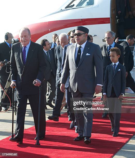 King Mohammed VI of Morocco and his son and Crown Prince Moulay El Hassan receive King Juan Carlos of Spain at the Rabat Sale airport on July 15,...