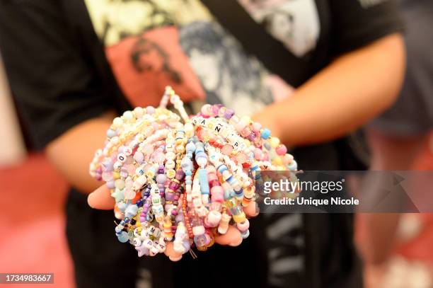 Taylor Swift fan, friendship bracelet detail, as seen during the world premiere of "Taylor Swift: The Eras Tour" on October 13, 2023 in Los Angeles,...