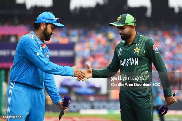Rohit Sharma of India and Babar Azam of Pakistan look on in the coin toss prior to the ICC Men's Cricket World Cup India 2023 between India and...