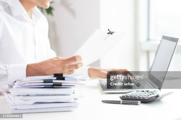 stack of documents, businessman in background - document stack stock pictures, royalty-free photos & images