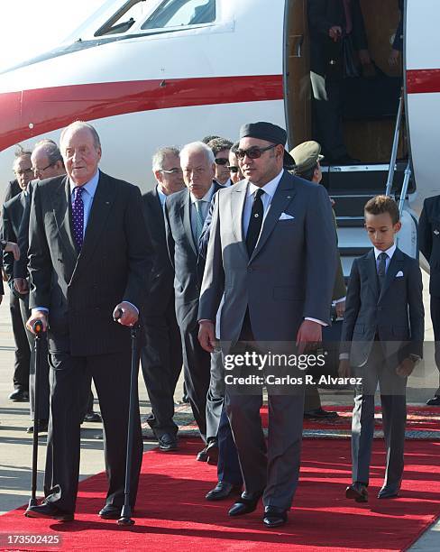 King Mohammed VI of Morocco and his son and Crown Prince Moulay El Hassan receive King Juan Carlos of Spain at the Rabat Sale airport on July 15,...