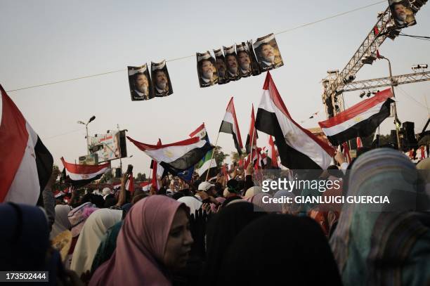 Muslim Brotherhood members and supporters of deposed president Mohamed Morsi wave national flags shouting slogans during a rally in his support...