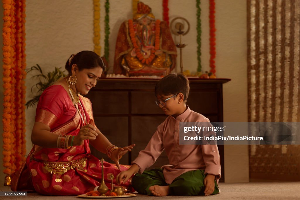 Mother and son celebrating Ganesh Chaturthi