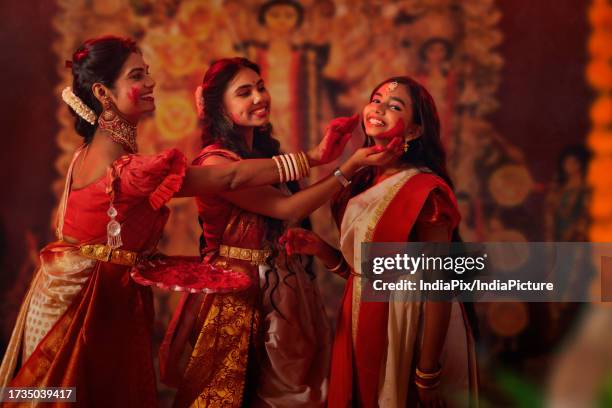 bengali family celebrating durga puja - bengali girl stock-fotos und bilder