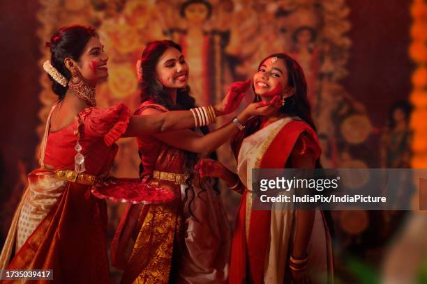 bengali family celebrating durga puja - west bengal stock pictures, royalty-free photos & images