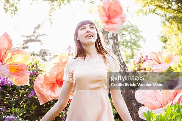 woman walking through nature with superflowers. - dream big foto e immagini stock