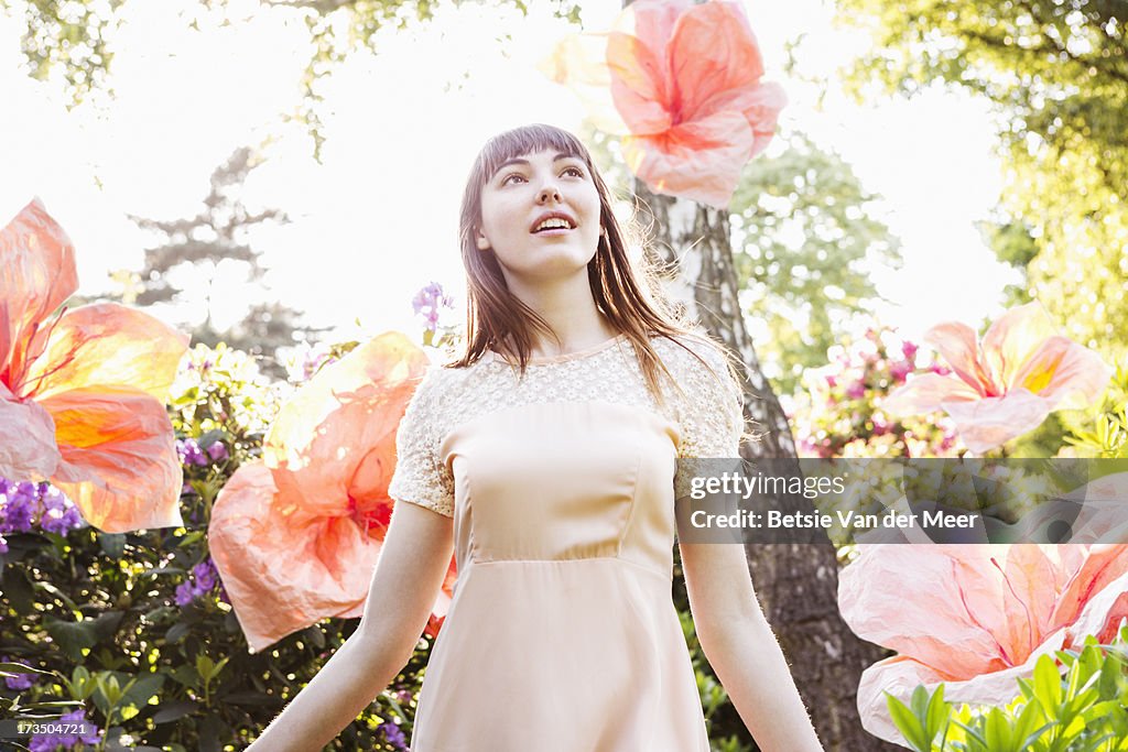 Woman walking through nature with superflowers.