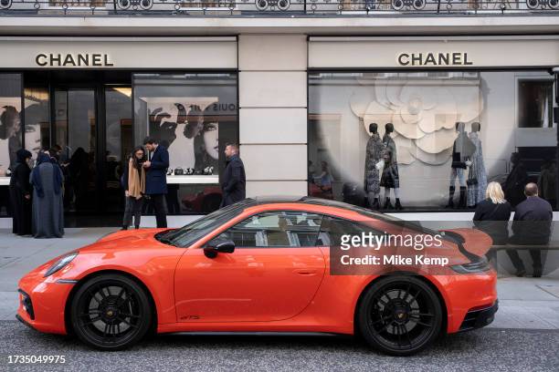 High end Porsche 911 Carrrera GTS car parked outside the Chanel store on Bond Street on 16th October 2023 in London, United Kingdom. Bond Street is...
