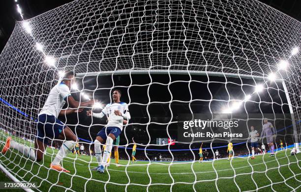 Ollie Watkins of England celebrates their teams first goal with Levi Colwill of England during the international friendly match between England and...