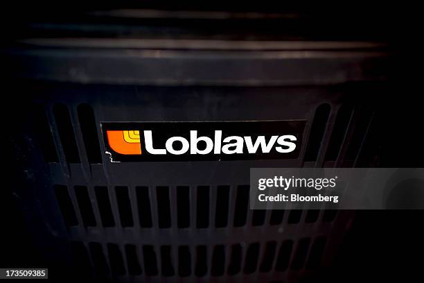 Loblaw Cos. Shopping baskets sit at a store in Toronto, Ontario, Canada, on Monday, July 15, 2013. Loblaw Cos. Agreed to buy Shoppers Drug Mart Corp....