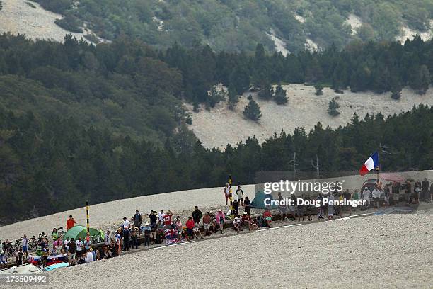 Fans await the cyclists on the slopes of the mountain during stage fifteen of the 2013 Tour de France, a 242.5KM road stage from Givors to Mont...