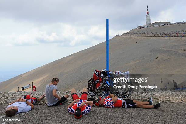 Norwegian cycling fans rest after riding up the mountain as they await the cyclists during stage fifteen of the 2013 Tour de France, a 242.5KM road...