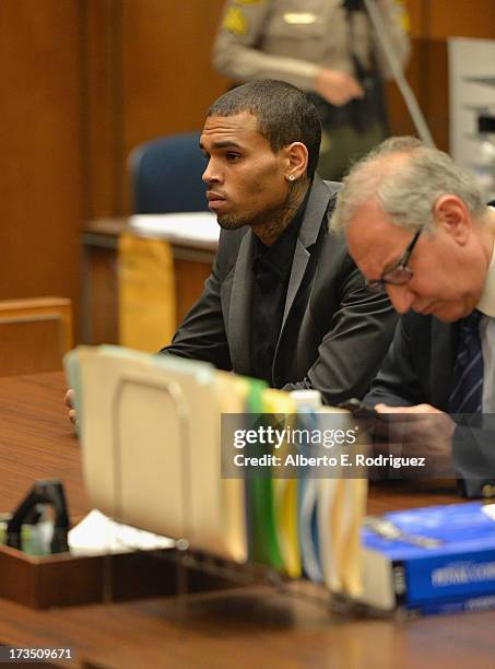 Recording artist Chris Brown and attorney Mark Geragow during Brown's court appearance on July 15, 2013 in Los Angeles, California. Brown appeared in...