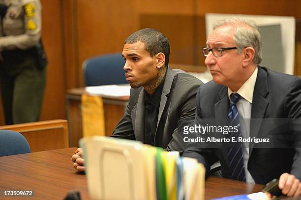 Recording artist Chris Brown and attorney Mark Geragow during Brown's court appearance on July 15, 2013 in Los Angeles, California. Brown appeared in...
