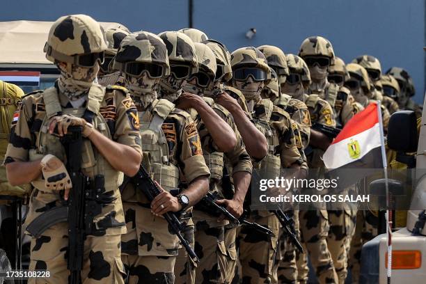 Egyptian army special forces soldiers deploy before the concrete barrier marking the border between Egypt and the Gaza Strip in Rafah in the east of...