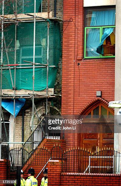 British police officers guard the entrance to the Finsbury Park Mosque after police conducted a raid in the early morning hours resulting in the...