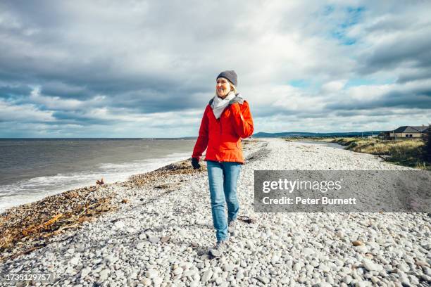 autumn walk on pebble beach, scotland - exercises stock pictures, royalty-free photos & images